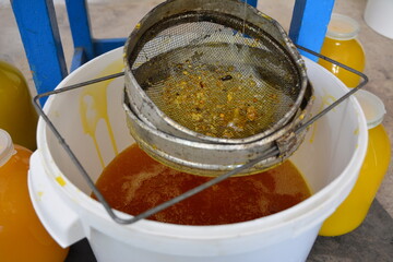 A grandpa's old sieve for straining honey at work.