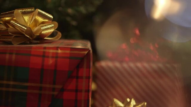 Close up of festive presents under decorated Christmas tree