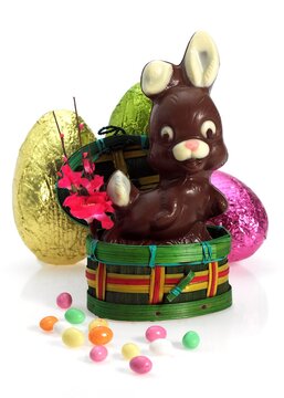 Chocolate Easter Rabbit and Eggs against White Background