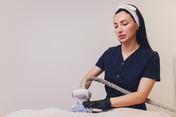 Parts of female body in special white suit having anti cellulite massage with spa apparatus.