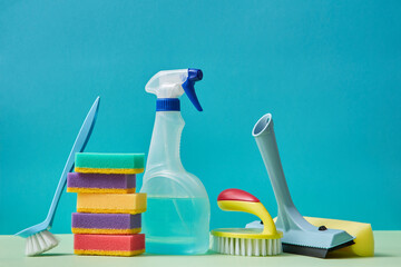 Cleaning materials. Housekeeping. Cleaning. Detergent nozzle colourful sponge. Brush with handle on blue background