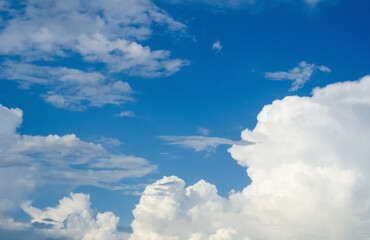 Blue sky in white cumulus clouds. Beautiful peaceful sky with large white and gray storm clouds. Summer sunny day. Good weather. The sky before the rain. Cumulus clouds