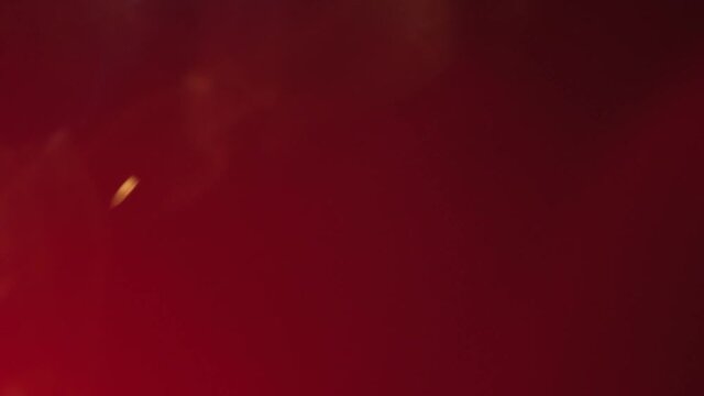 Close up of red spot light beam flaring 