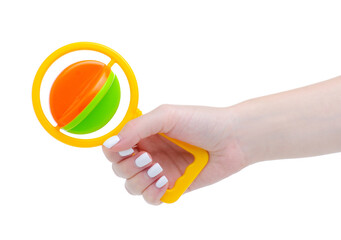 Baby colorful rattle in hand on white background isolation
