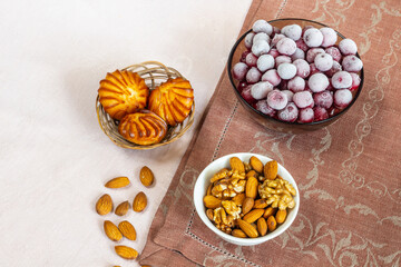 Frozen cherry and almond nuts for breakfast. Every day healthy breakfast. Beige and brown linen background. Flat lay