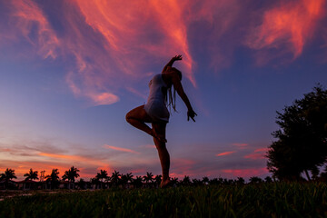 Young woman dancing in the sunset
