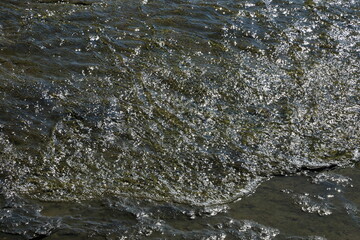 Clear water ripples with sunlight 