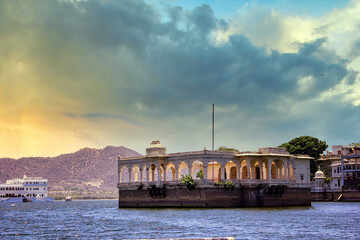 Udaipur, India - May 25, 2013: Architecture built within Lake Pichola surrounded by hills against...
