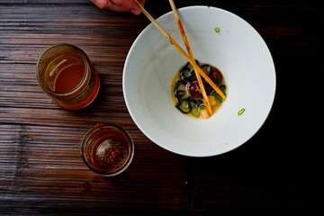 Ramen noodles. Japanese classic soup, with noodles, broth, pork, chicken, tofu, scallions, mushrooms, eggs and red pepper sauce. Copy space.