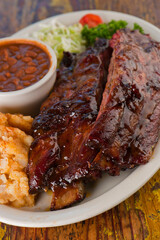 Brisket, pork sausage, pork ribs, beef ribs. Barbecue platter served with classic bbq sides Mac n cheese, cornbread, Brussels sprouts, coleslaw & beer. Classic traditional Texas meats & side dishes.