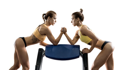 two young fitness woman, arm wrestling in gym