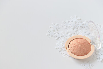 Make-up concept. White background with blush for a face with and decorative snow on a white background. Isolated. Copy space.