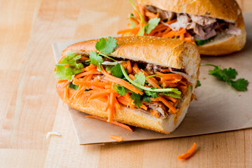 Bánh mì or banh mi, Vietnamese word for bread. Traditional classic Vietnamese cuisine. Baguette with pate, pulled pork, jalapenos, cilantro, carrots cucumbers and spicy sauce.