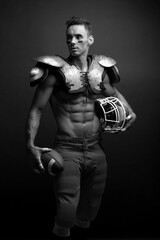Fototapeta na wymiar Young male brunette poses in the clothes of an American football player