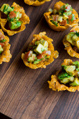 Spicy Guacamole served in crispy taco shells with salsas, cilantro and lime. Avocados diced and mixed with lemon and lime juices. Classic Tex-Mex, Mexican or American restaurant appetizer favorite.
