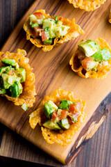 Spicy Guacamole served in crispy taco shells with salsas, cilantro and lime. Avocados diced and mixed with lemon and lime juices. Classic Tex-Mex, Mexican or American restaurant appetizer favorite.