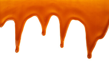Background of flowing caramel sauce isolated on white.