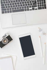 Flat lay mockup smartphone blank screen, laptop a cup of coffee on a white background