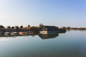 Fototapeta na wymiar boats stands near boathouse in a lake