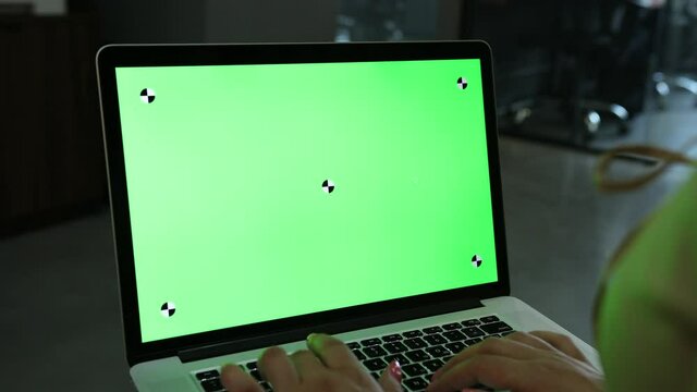 Laptop template with white transparent screen, computer blank display isolated. Metal device. Fingers press keys of the keyboard. Green