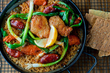 Paella. Traditional classic Spanish seafood dish with fresh seafood, shrimp, mussels, clams, squid cooked in fish broth with saffron and rice garnished with cilantro. 