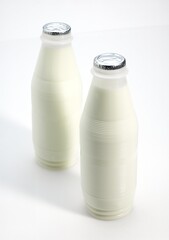 Bottles of Milk against White Background