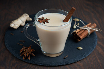 Hot indian masala chai or mixed spice tea made of milk and variety of aromatic herb such as anise...