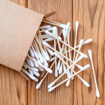 Eco-friendly cotton swabs. View from above. Square image. Wood background
