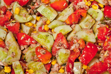 Lettuce texture close up. Fresh salad of vegetables, tomatoes and cucumbers.