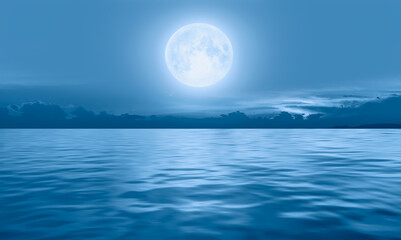 Fototapeta na wymiar Night sky with moon in the clouds dark sea in the background 