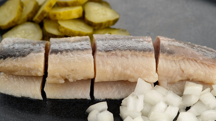 Holland Soused herring with onion and dill pickles cucumbers