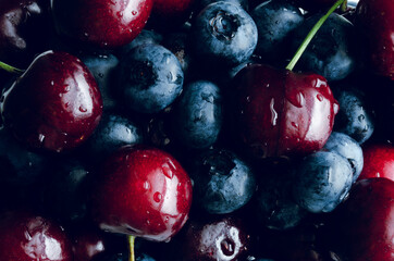 Blueberry and cherry background. Macro concept.