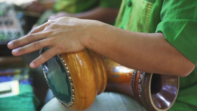 Focused Shot of Man's Arms as He Plays the Thai Hand Drums