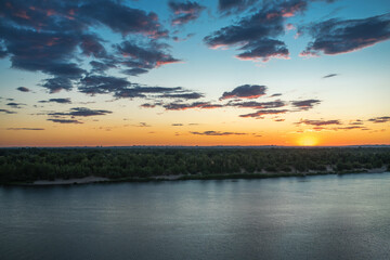Obraz premium In the evening at sunset the reflection of clouds in the water. Summer evening in nature. Beautiful landscape.