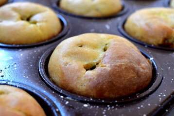 Hand-made Apple cupcakes in a baking dish close-up