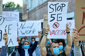 Large group of protesters with protective face masks due to coronavirus epidemic.