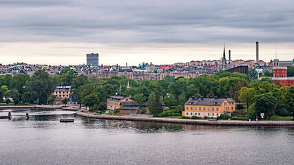 Panoramic view of different parts of Stockholm from the observation deck, cloudy summer day with blurry small fragments in the corners of the card