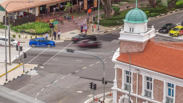 Aerial view of intersection and art deco shophouses with red roofs along Neil road in Chinatown area timelapse. Traffic on the street with crossroad and crossing