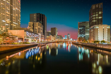 Fototapeta na wymiar Illuminated buildings on Tosabori River side at night in Osaka Japan