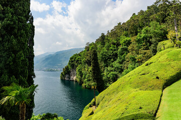 Fototapeta na wymiar Lake Como coastline, view of the lake and surrounding mountains