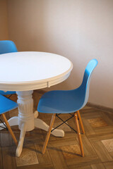 blue plastic chair and white wooden table