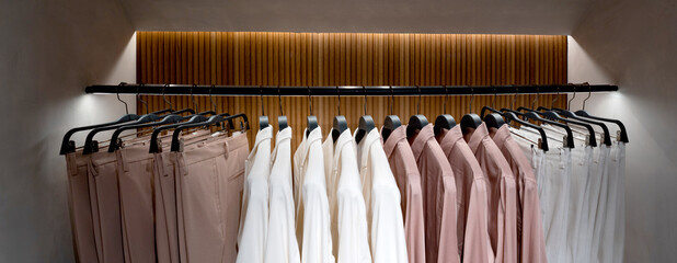 Collection of clothes hangs on the counter. Shoe store in modern mall.