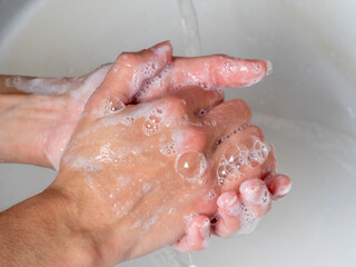 hand washing with soap. Concept of personal hygiene, countering viruses and microbes