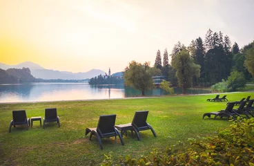 Poster Many armchairs on the grass with no people by the bled lake in Slovenia during the morning Nature retriet in central europe and Slovenia. © Evaldas