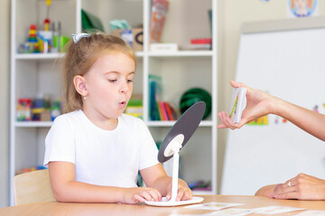 developmental and speech therapy classes with a child-girl. Speech therapy exercises and games with...