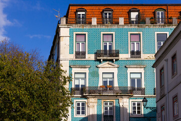 Fototapeta premium Blue tiles front facade of Lisbon building on sunny day. Traditional architecture in Portugal capital. Language translation: Graca street