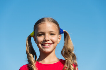 Cheerful little girl adorable ponytails hairstyle outdoors, true happiness concept