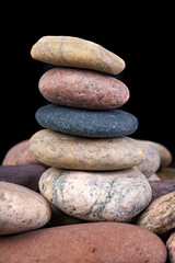 Fototapeta na wymiar Dry oval stones found on the seashore. Stones stacked up.