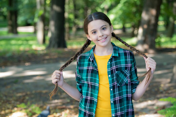 Girl scout cute braids wear checkered clothes nature background, camping concept
