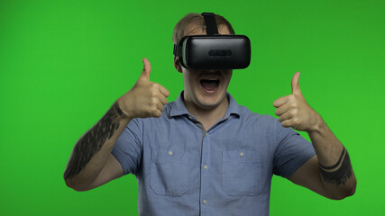 Man using VR headset helmet to play game. Watching virtual reality 3d 360 video. Chroma key